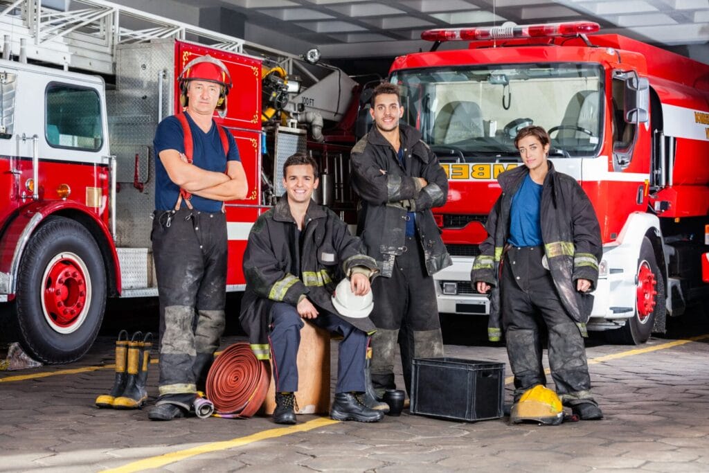 Firefighters in front of fire trucks