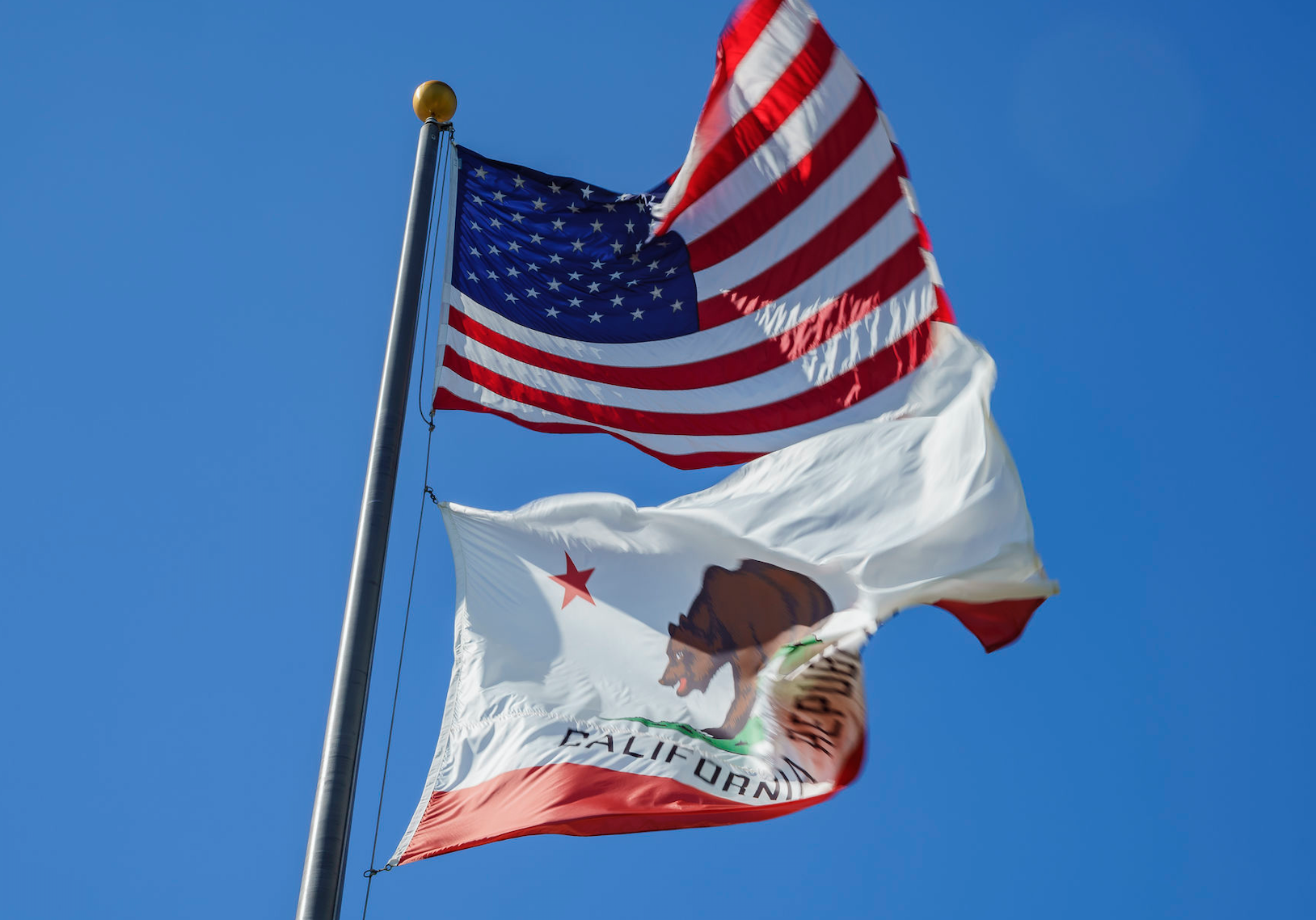 US and California flags on flag pole
