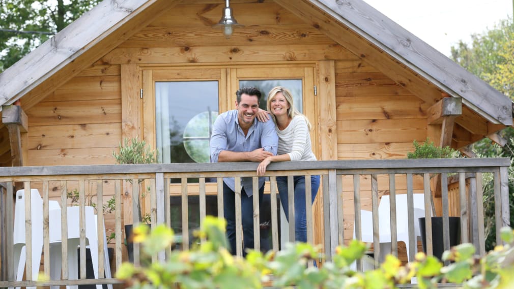 Couple standing in log cabin terrace