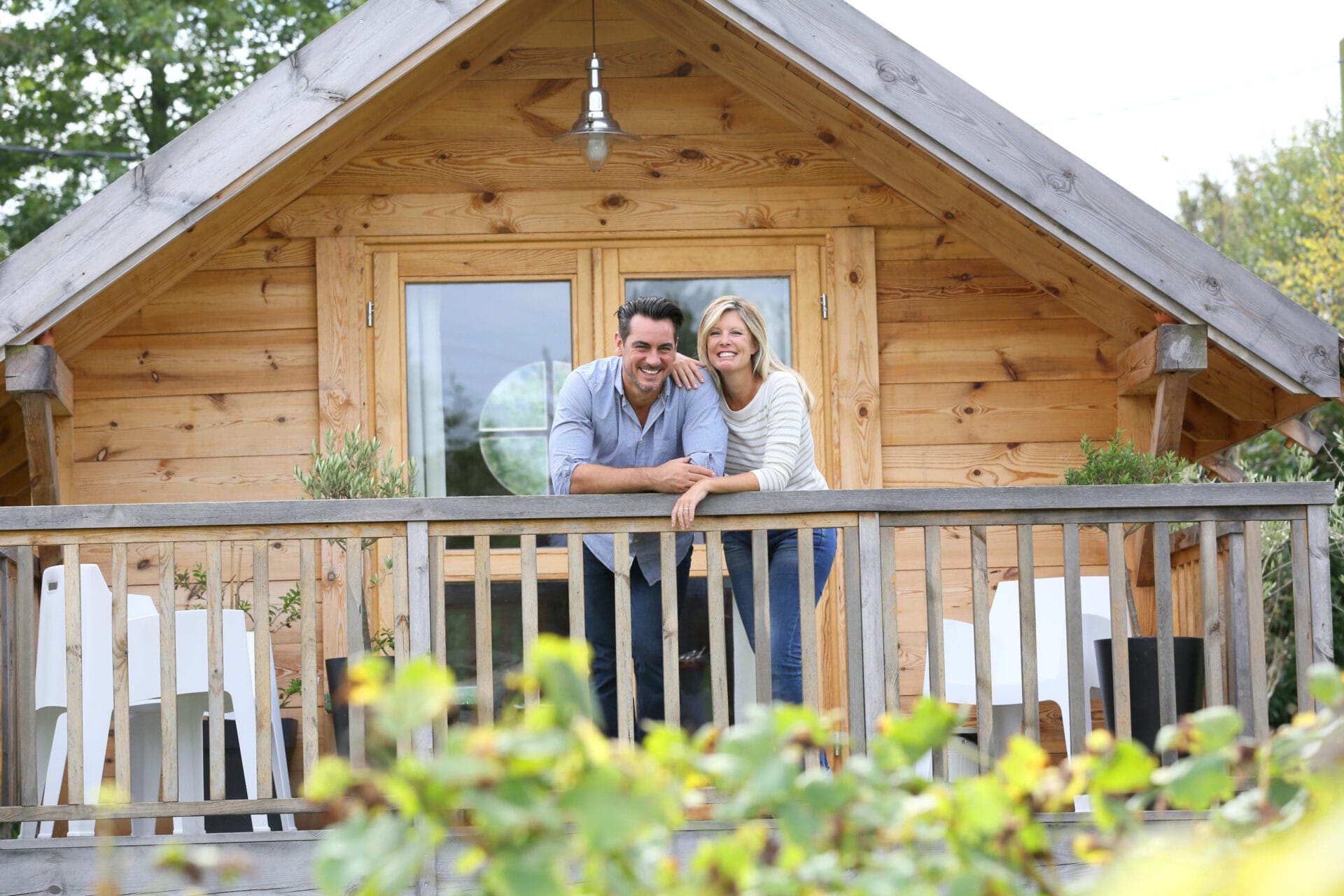 Couple standing in log cabin terrace