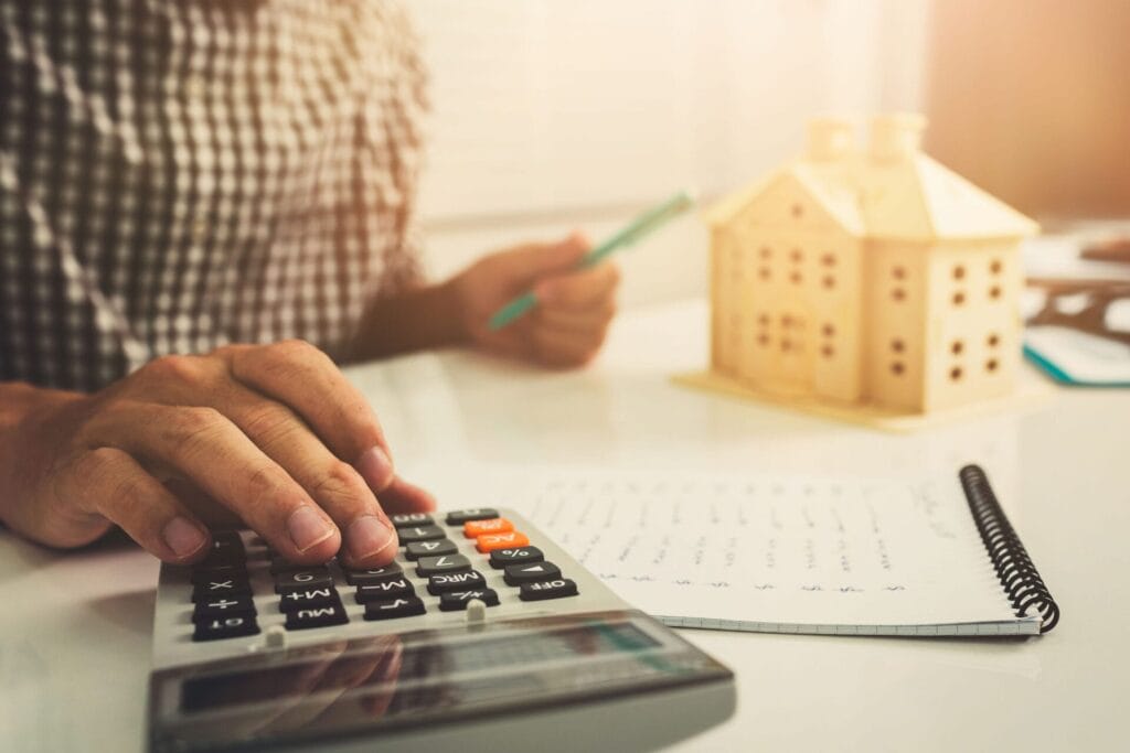 Young business man doing calculator finance cost in home office.