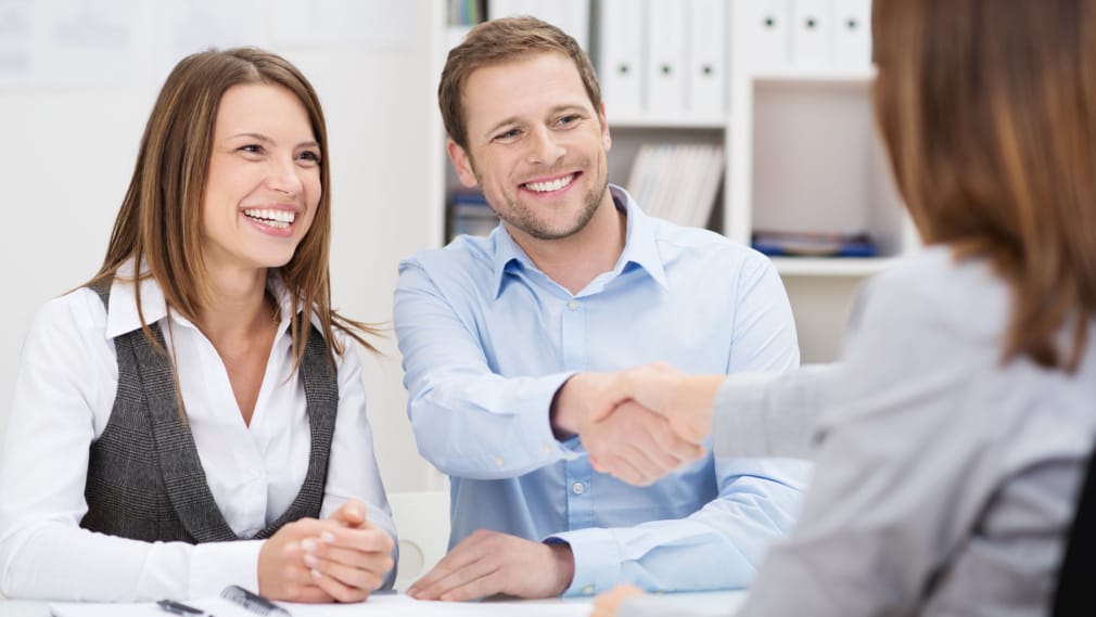 Smiling man shaking hands with agent