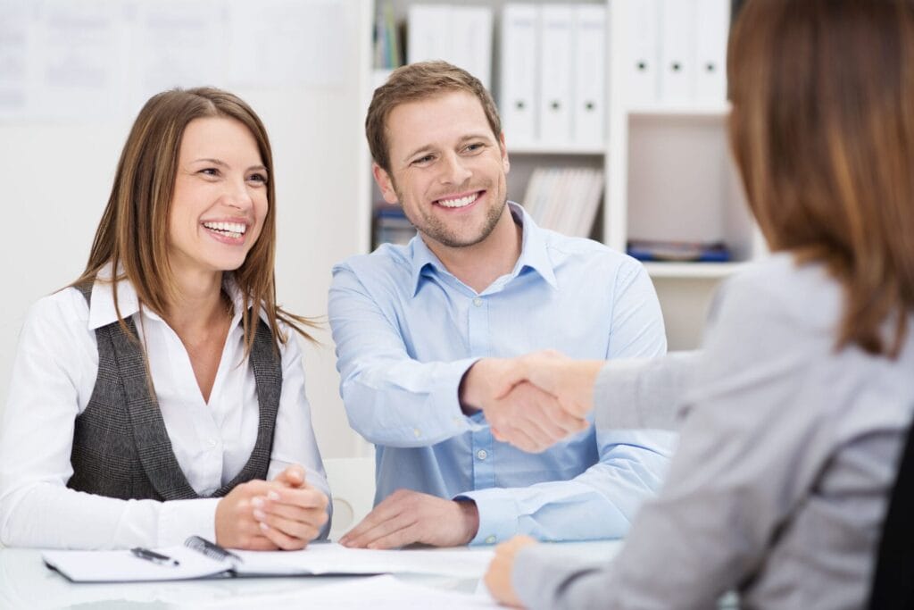 Smiling man shaking hands with agent